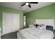 A charming bedroom with a large closet, white furniture, and view into the living room at 605 Black Eagle Dr, Groveland, FL 34736