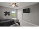 Stylized bedroom with a decorative wall, large window and closet, and a flat screen TV at 605 Black Eagle Dr, Groveland, FL 34736