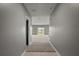 Bright hallway featuring neutral paint, leading to the living area with expansive windows and natural light at 605 Black Eagle Dr, Groveland, FL 34736