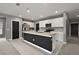Modern kitchen featuring a dark island, white cabinets, stainless steel appliances, and ample counter space at 605 Black Eagle Dr, Groveland, FL 34736
