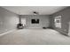 Large living room with neutral decor, a ceiling fan, and several windows offering plenty of natural light at 605 Black Eagle Dr, Groveland, FL 34736