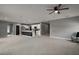 Open layout with living room view of the kitchen, featuring a black island, and dining area at 605 Black Eagle Dr, Groveland, FL 34736