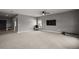 Open-concept living space with neutral walls, modern decor, and easy access to the kitchen and entryway at 605 Black Eagle Dr, Groveland, FL 34736