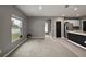 A spacious living room with gray walls, neutral carpet, and lots of natural light at 605 Black Eagle Dr, Groveland, FL 34736