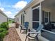 Backyard featuring a patio with outdoor chairs and a well-maintained yard at 6301 Whittle Ct, The Villages, FL 32163