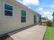 Backyard features updated sliding doors and windows to let the light in with a quaint green lawn at 6301 Whittle Ct, The Villages, FL 32163