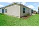 Backyard showcasing well-manicured lawn, tasteful landscaping and easy access to patio at 6301 Whittle Ct, The Villages, FL 32163