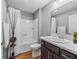 Bathroom features a shower and tub combo with updated vanity and stylish decorative pieces at 6301 Whittle Ct, The Villages, FL 32163