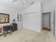 Well-lit bedroom features carpet, closet, ensuite access, and adjacent desk area with storage at 6301 Whittle Ct, The Villages, FL 32163