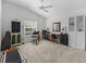 Bright bedroom features a ceiling fan, guitar and music area, and a built-in desk space at 6301 Whittle Ct, The Villages, FL 32163