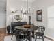 Features a modern dining table, buffet with lamps, and a large round mirror with great lighting at 6301 Whittle Ct, The Villages, FL 32163