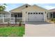 Inviting single-story home with a white picket fence, two-car garage, and manicured lawn at 6301 Whittle Ct, The Villages, FL 32163