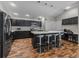 Modern kitchen featuring dark cabinets, stainless steel appliances, a large island and ample counter space at 6301 Whittle Ct, The Villages, FL 32163