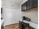 Features a built-in desk area next to a pantry with a modern coffee maker and dark cabinets at 6301 Whittle Ct, The Villages, FL 32163