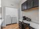 Laundry room features updated washer and dryer, countertop, and storage, adding convenience at 6301 Whittle Ct, The Villages, FL 32163