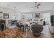 Cozy living room with vaulted ceilings, hardwood floors, and access to the patio through sliding glass doors at 6301 Whittle Ct, The Villages, FL 32163
