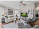 Inviting living room with golf course views, plush seating, and natural light, perfect for relaxation at 6301 Whittle Ct, The Villages, FL 32163