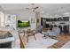 Comfortable living room featuring stylish decor, vaulted ceilings, and an open layout to the kitchen at 6301 Whittle Ct, The Villages, FL 32163