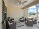 Covered patio featuring ample seating, ceiling fan and adjacent views of fenced backyard at 6301 Whittle Ct, The Villages, FL 32163