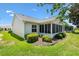 Cozy home showcasing a neat backyard and screened-in porch, set in a tranquil neighborhood at 654 Fayette Ct, The Villages, FL 32162