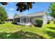 Charming home featuring a well-maintained backyard with a screened-in porch, perfect for relaxation and entertaining at 654 Fayette Ct, The Villages, FL 32162