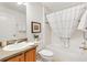 Well-maintained bathroom features a tub with shower, framed art, and updated vanity at 654 Fayette Ct, The Villages, FL 32162