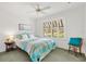 Well-lit bedroom features a bright window, side table, and charming decor at 654 Fayette Ct, The Villages, FL 32162