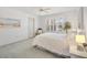 Light-filled bedroom with soft carpet, a large window with shutters, and neutral decor at 654 Fayette Ct, The Villages, FL 32162