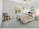 Inviting bedroom with soft carpet, a side chair, shuttered window, and a cozy atmosphere at 654 Fayette Ct, The Villages, FL 32162