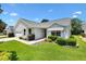 Charming single story home featuring a well-maintained lawn and attached garage at 654 Fayette Ct, The Villages, FL 32162