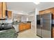 A view of the kitchen and adjoining living space with vaulted ceiling at 654 Fayette Ct, The Villages, FL 32162