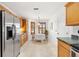 Bright kitchen and breakfast nook with tile flooring and stainless steel refrigerator at 654 Fayette Ct, The Villages, FL 32162