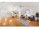 Bright open-concept living space with hardwood floors, a dining area, and lots of natural light at 654 Fayette Ct, The Villages, FL 32162