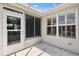 Enclosed back porch with tile flooring and screens at 654 Fayette Ct, The Villages, FL 32162