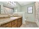 Bathroom vanity with granite countertop, mirror, and wood cabinets at 717 Southeast 46Th Ct, Ocala, FL 34471