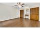 Bright bedroom with wood-look floors, ceiling fan, two closets, and a built-in vanity niche with a window at 717 Southeast 46Th Ct, Ocala, FL 34471