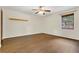Spacious bedroom featuring wood-look floors, a ceiling fan, and a window for plenty of natural light at 717 Southeast 46Th Ct, Ocala, FL 34471