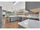 Modern kitchen boasts gray cabinets, quartz countertops, and stainless steel appliances at 717 Southeast 46Th Ct, Ocala, FL 34471