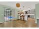 Open-concept kitchen with island seating flows seamlessly into the dining area and pool view at 717 Southeast 46Th Ct, Ocala, FL 34471