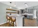 Contemporary kitchen with island seating, gray cabinets, and modern pendant lighting at 717 Southeast 46Th Ct, Ocala, FL 34471