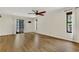 Open living room featuring wood floors, large windows and a sliding door at 717 Southeast 46Th Ct, Ocala, FL 34471