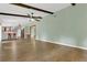 Spacious living area with wood-look floors, ceiling fan and views to the kitchen at 717 Southeast 46Th Ct, Ocala, FL 34471
