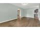 Open living room featuring wood-look floors, neutral paint, and open layout to the kitchen at 717 Southeast 46Th Ct, Ocala, FL 34471