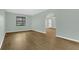 Inviting living room features hardwood floors and natural light from a large window at 717 Southeast 46Th Ct, Ocala, FL 34471