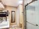 Bathroom with a double vanity, decorative mirrors, and a shower with a sliding glass door at 750 Eden Pl, The Villages, FL 32162