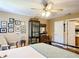 Bedroom with a ceiling fan, wood floors, and framed pictures on the wall at 750 Eden Pl, The Villages, FL 32162