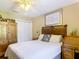 Bedroom featuring a bed with white linens, vintage decor, and a bright window at 750 Eden Pl, The Villages, FL 32162