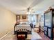 Bedroom with a ceiling fan, wood floors, and an area rug at 750 Eden Pl, The Villages, FL 32162