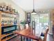 Dining area featuring a bar, dining table with seating, and sliding glass doors to outdoor space at 750 Eden Pl, The Villages, FL 32162