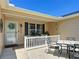 Charming front porch with outdoor seating and a decorative wreath on the front door at 750 Eden Pl, The Villages, FL 32162
